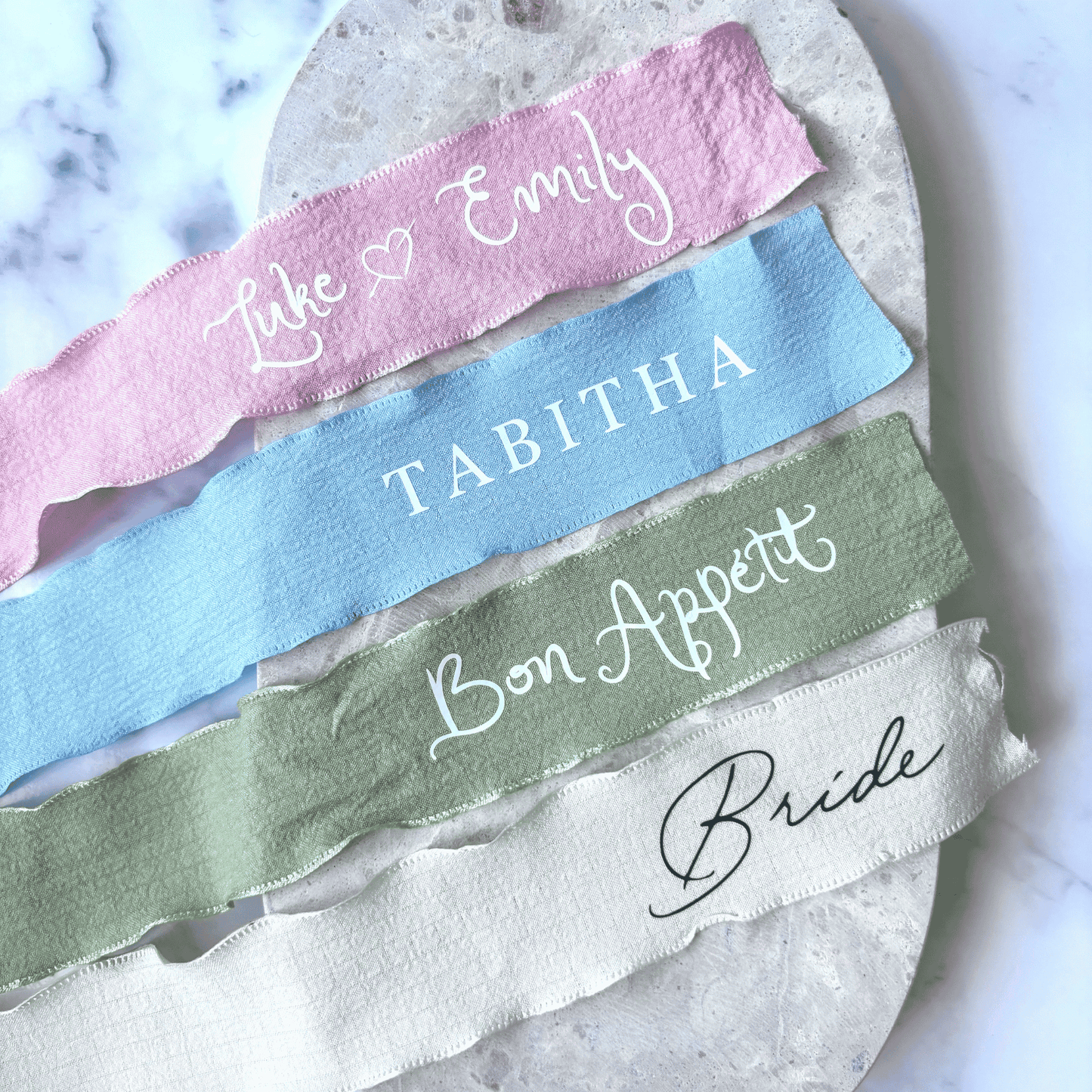Personalised wedding ribbons in assorted colours, custom wedding stationery for menus or table décor