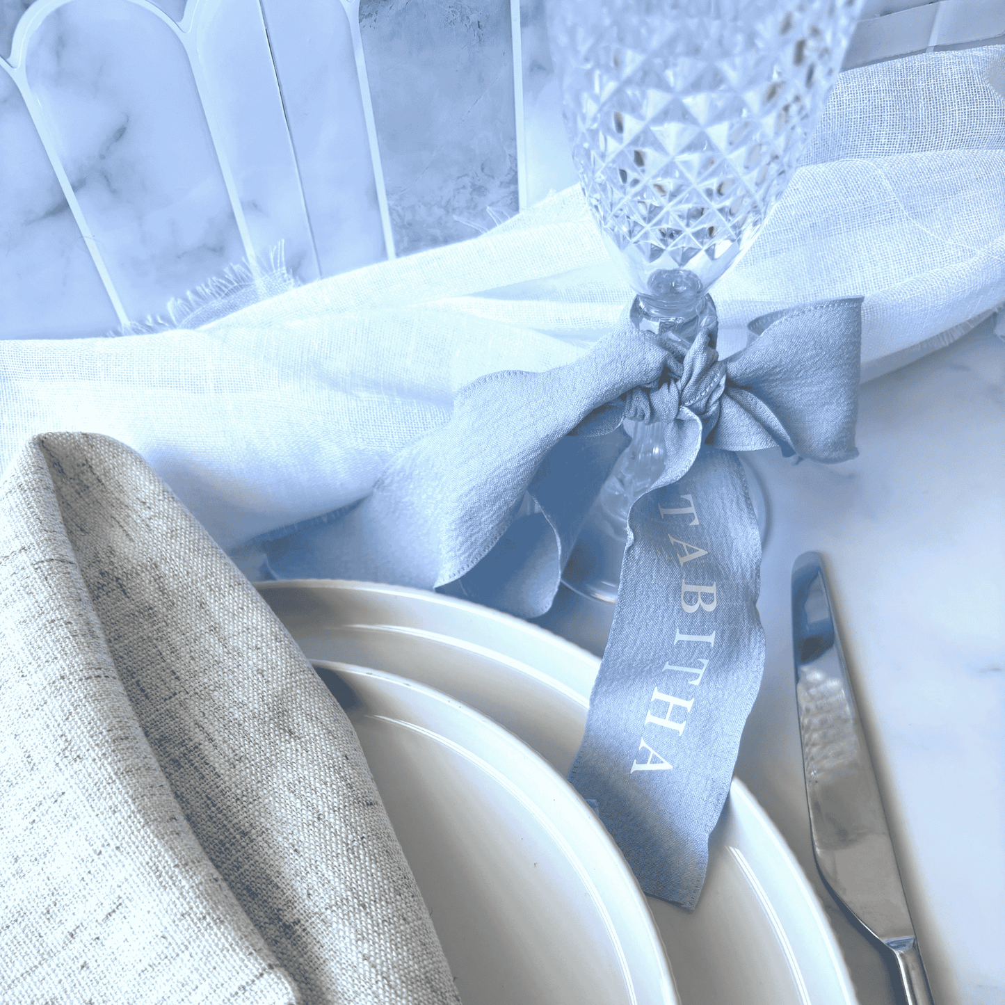 Custom blue wedding ribbon tied to glassware, perfect for wedding table settings or event accessories