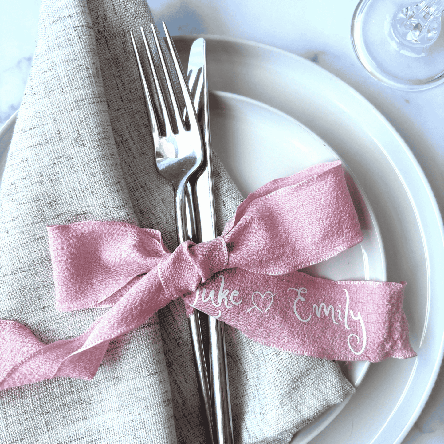 Personalised pink wedding ribbon with names, ideal for custom wedding stationery or table decoration