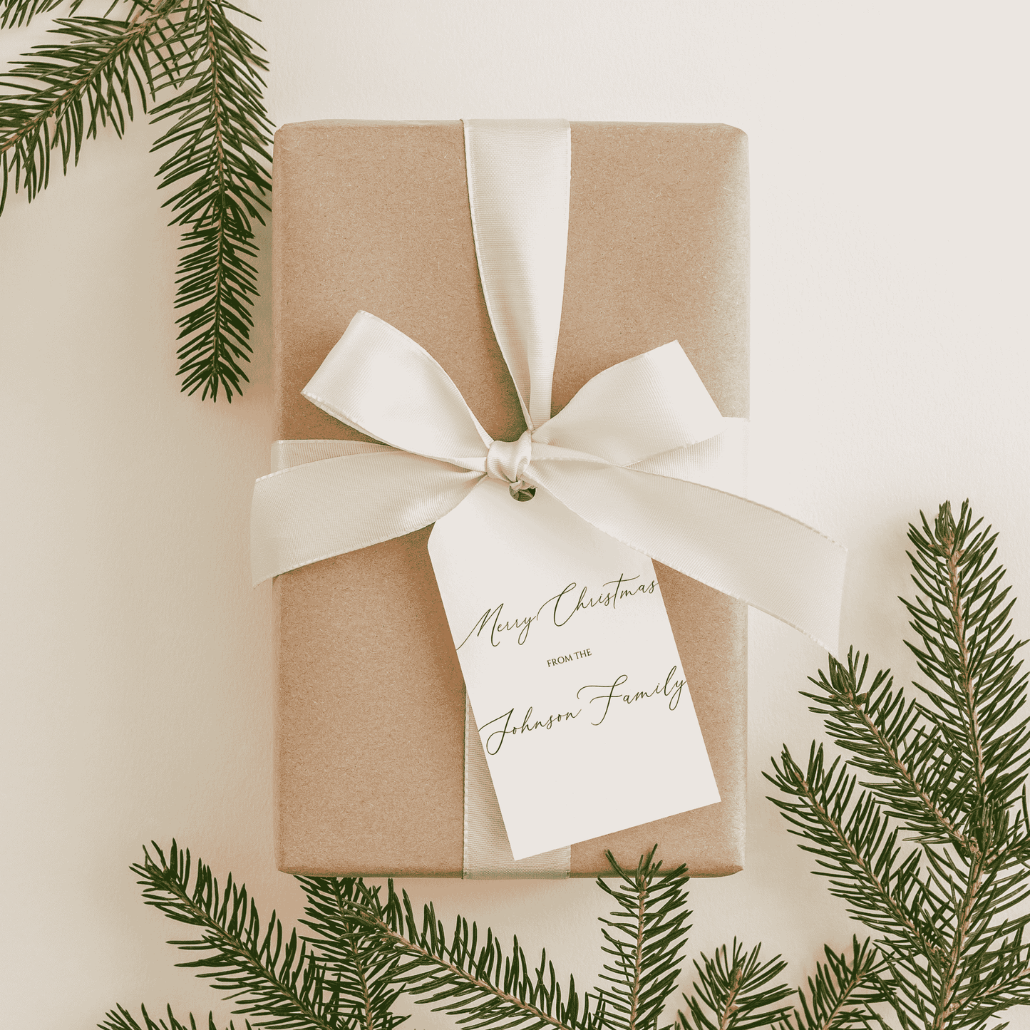 Handmade Christmas gift tag tied to wrapped present with ribbon, personalised stationery accessory for festive gifting