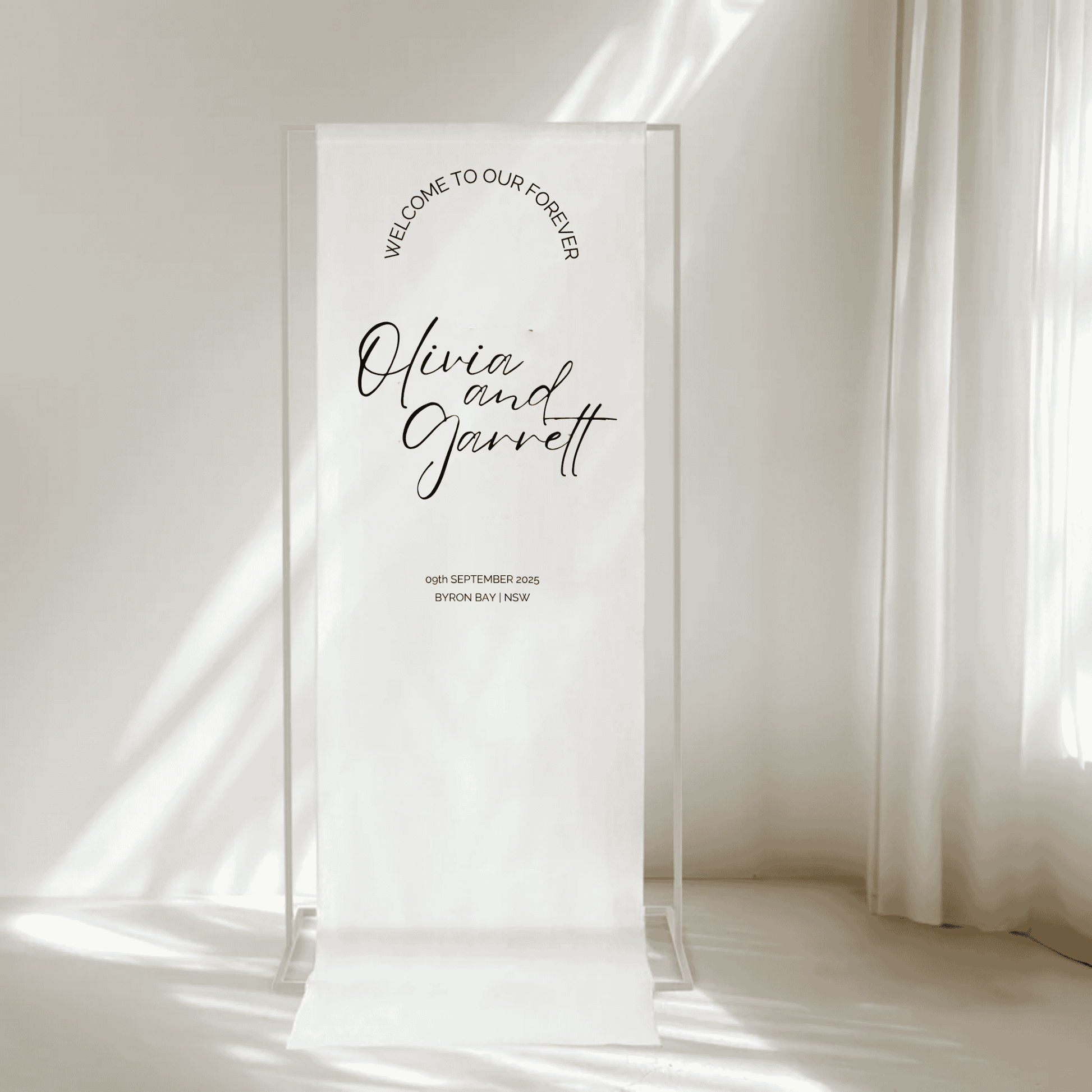 Classic wedding welcome sign on fabric with couple’s names, ideal for simple, timeless wedding signage