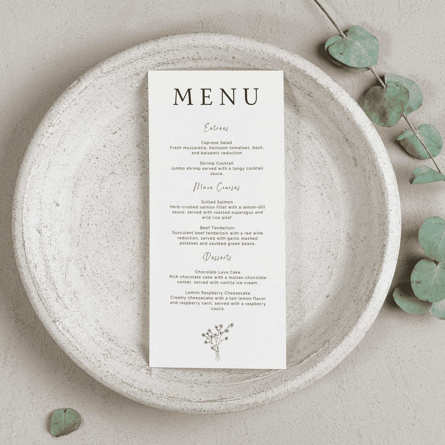 Daisy wedding menu on textured plate with greenery styling for wedding table settings and simple wedding stationery