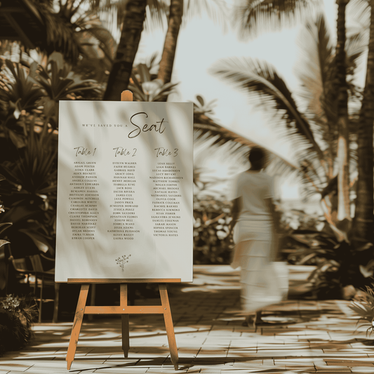 Daisy wedding seating sign on easel in tropical outdoor venue for wedding seating sign and wedding signage