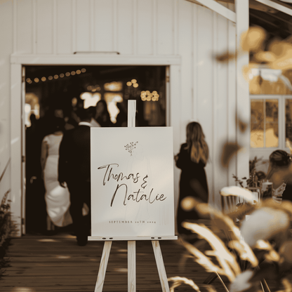 Daisy wedding welcome sign on wooden easel at venue entrance for wedding signage and wedding decoration