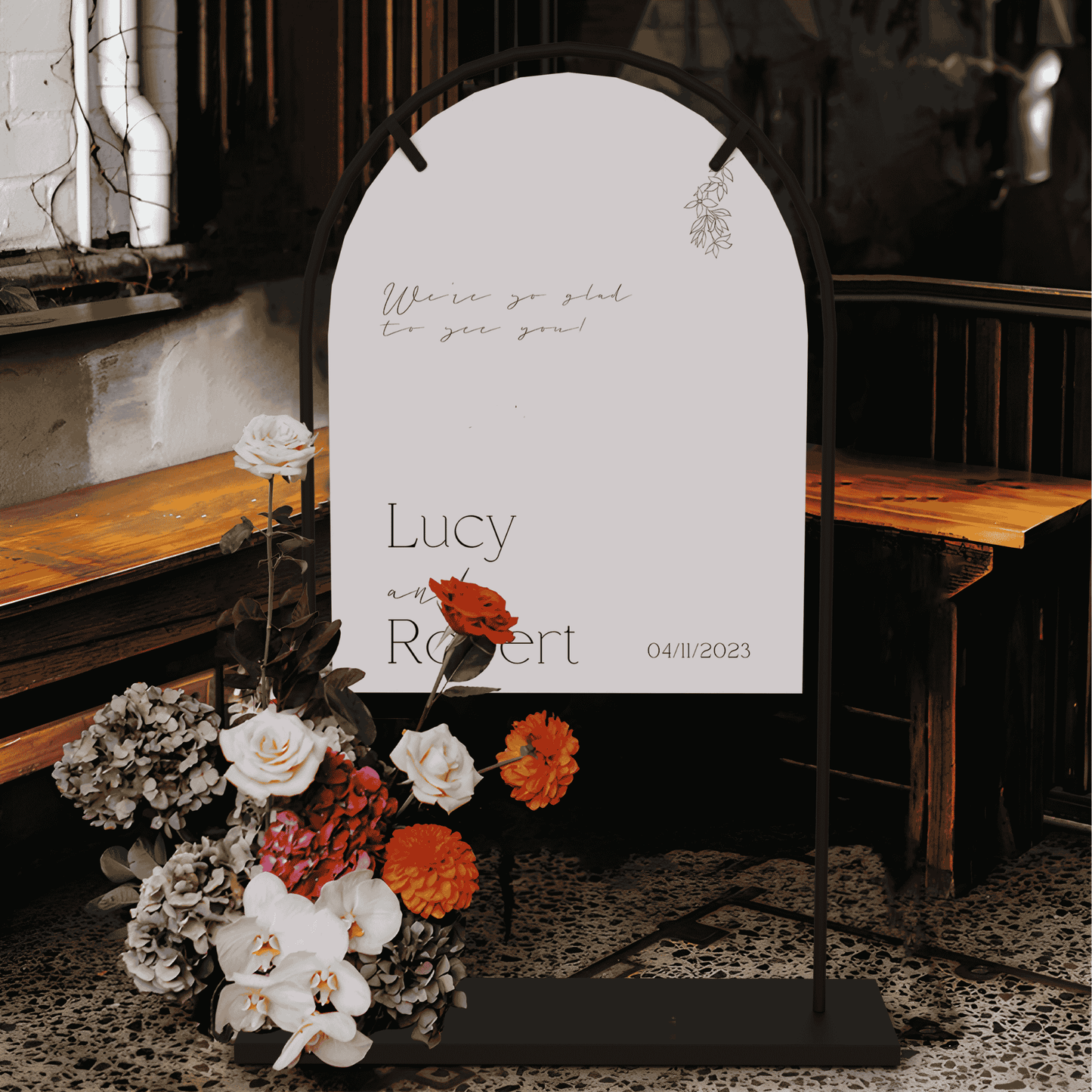 Flora wedding welcome sign displayed on stand with floral arrangement used as wedding signage and wedding decoration