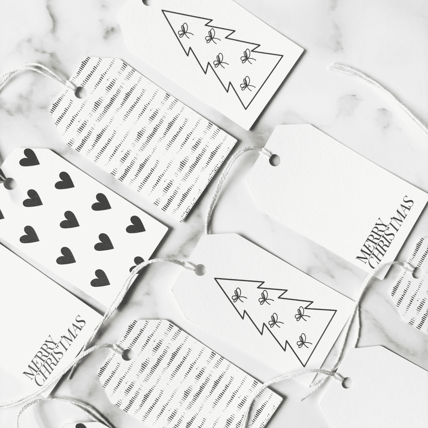 Assorted handmade Christmas gift tags with black heart designs and plain tags, ideal for wedding stationery and Christmas packaging