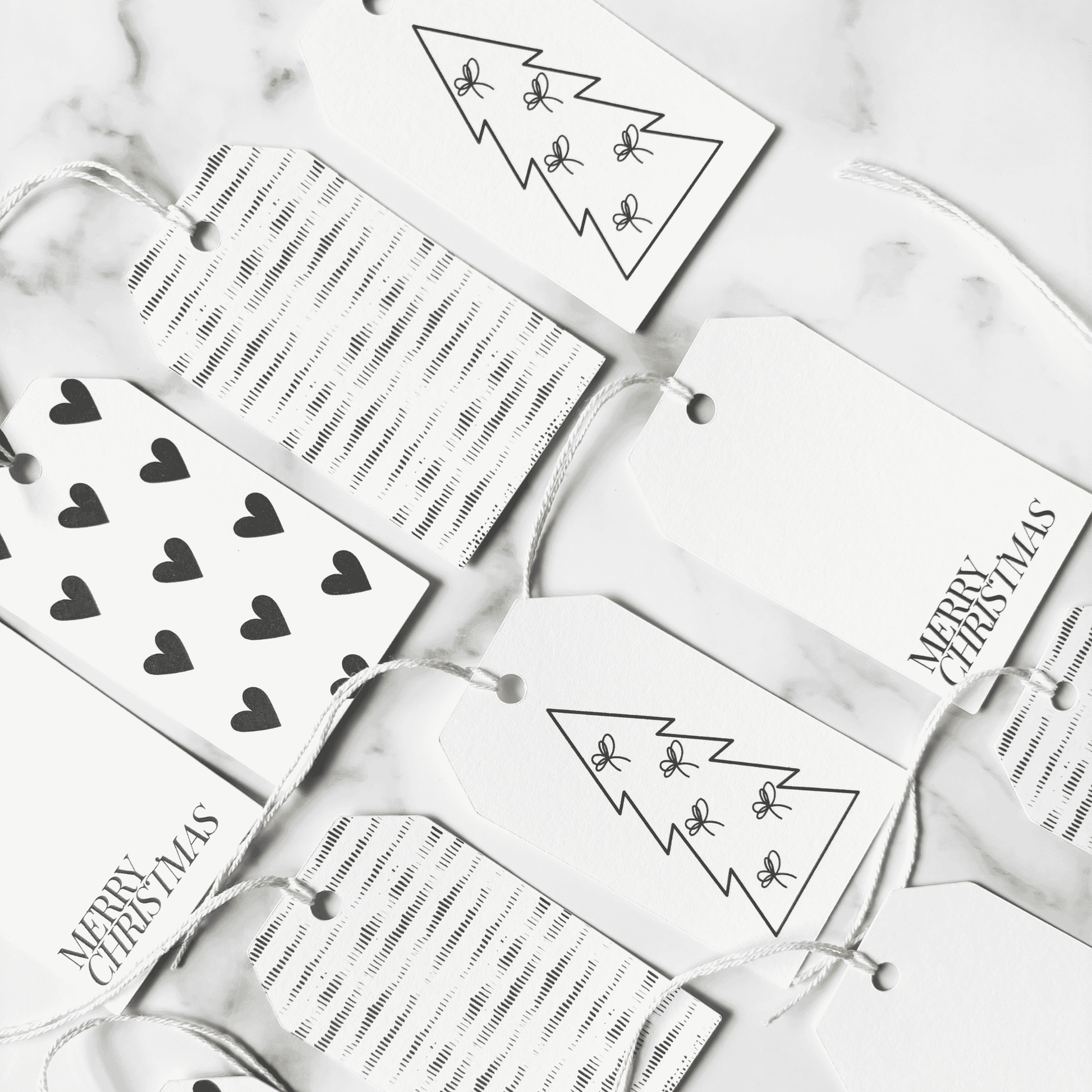 Assorted handmade Christmas gift tags with black heart designs and plain tags, ideal for wedding stationery and Christmas packaging