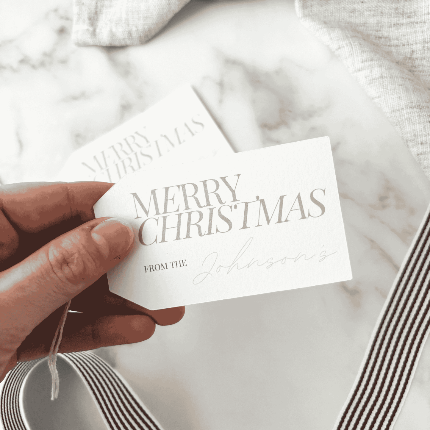 Personalised Merry Christmas gift tag with family name, handmade paper stationery for gift wrapping and wedding favours