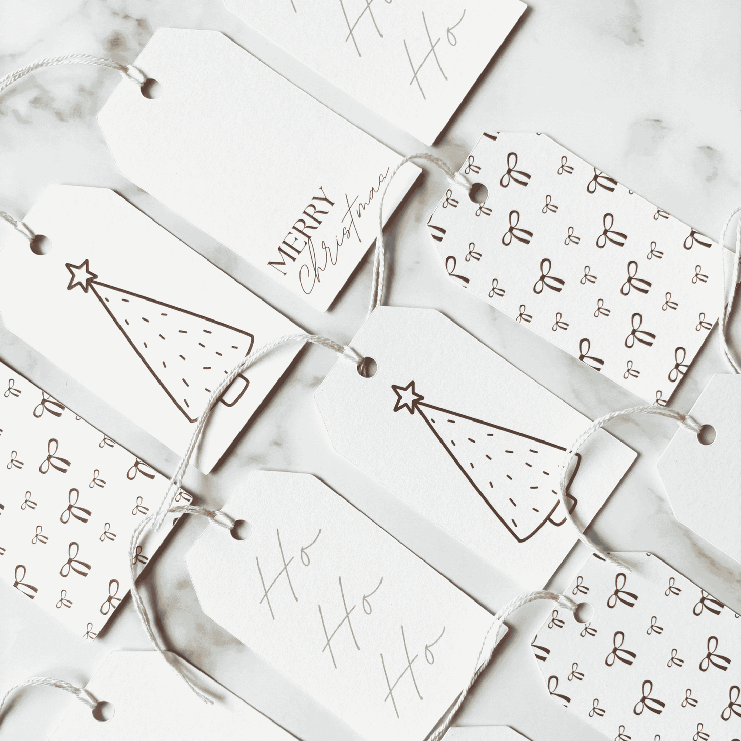 Handmade Christmas gift tags featuring bow patterns, Christmas tree illustration and Merry Christmas text, perfect for Christmas gift wrapping