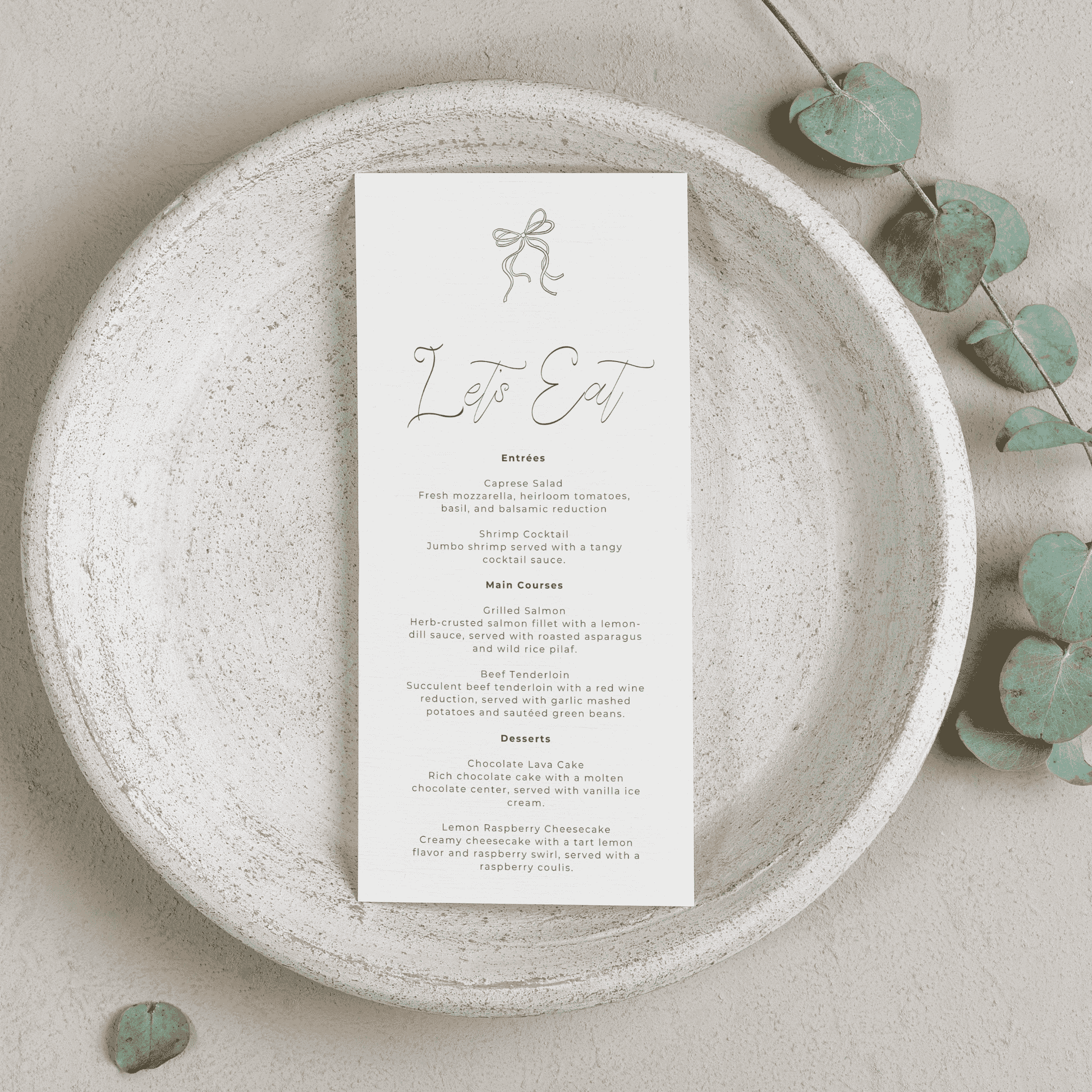 Handwritten wedding menu card with bow and foliage styling for wedding invitation suites and wedding table settings