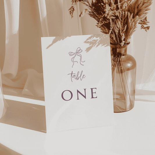 Handwritten wedding table number one card with ribbon design, perfect for modern invitation suites