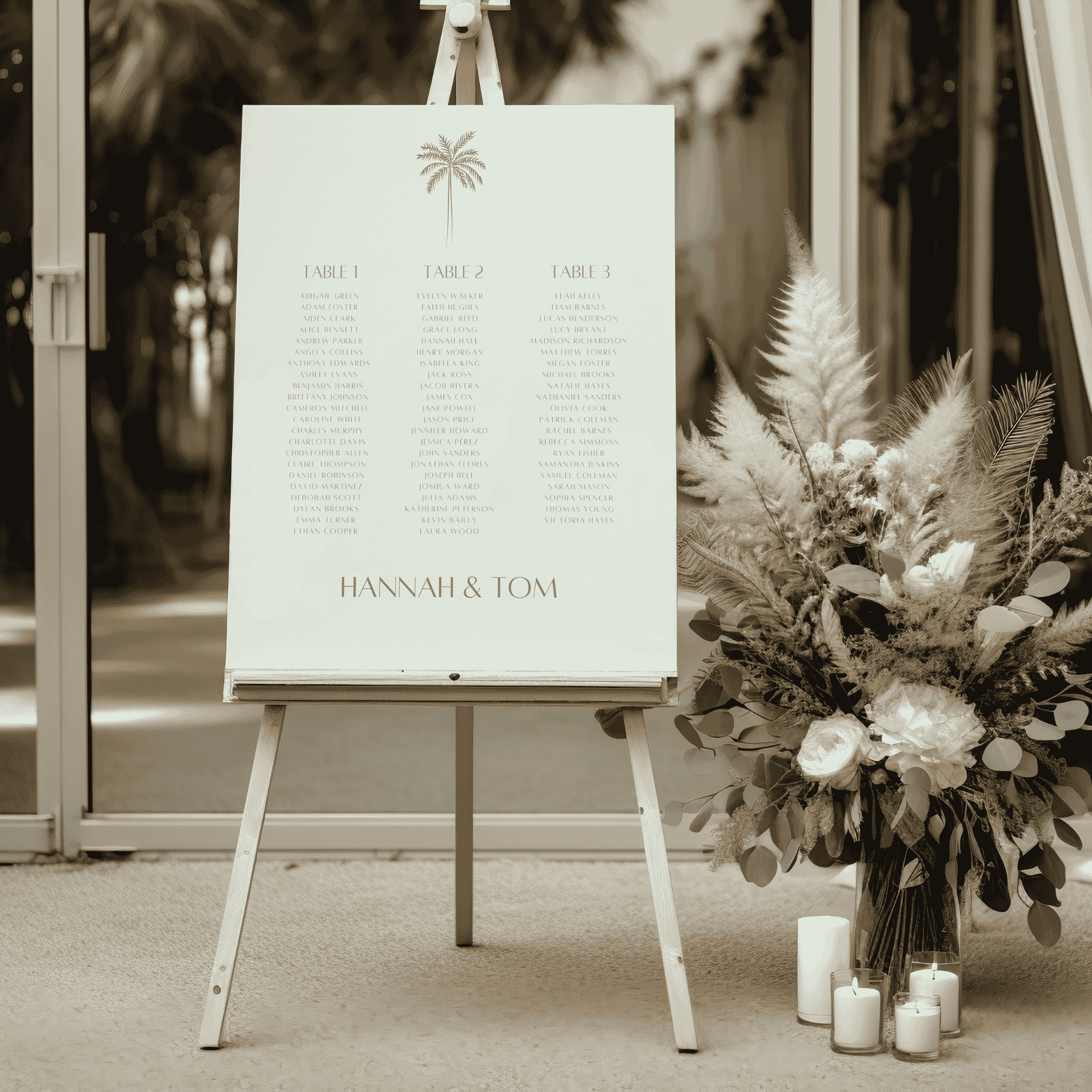 Palm wedding seating sign on easel at venue entrance with dried florals and candles