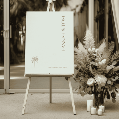 Palm wedding welcome sign displayed on easel with native florals styled for wedding signage and wedding decoration