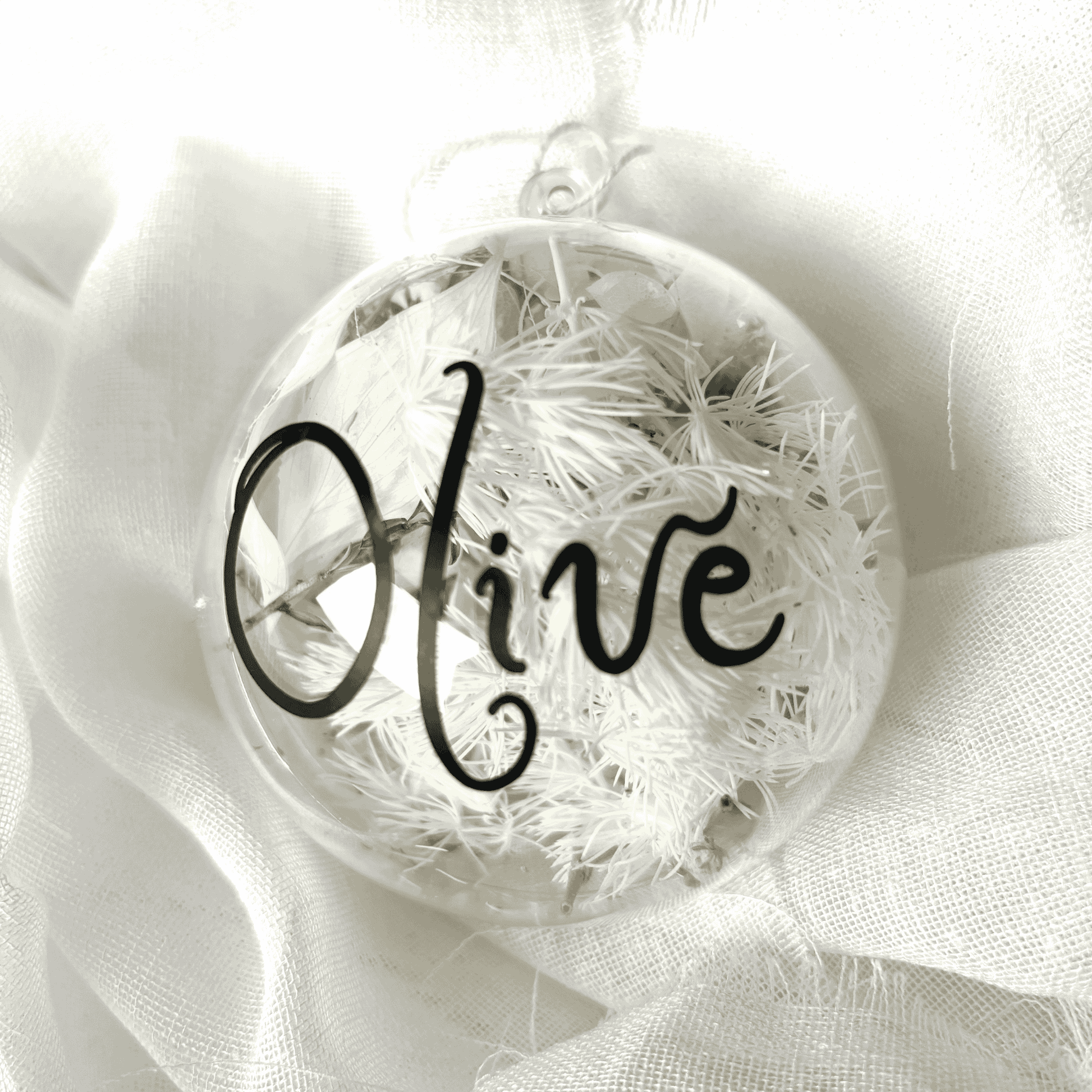 Personalised dried floral Christmas bauble with white florals and black name text, perfect for Christmas tree decorating