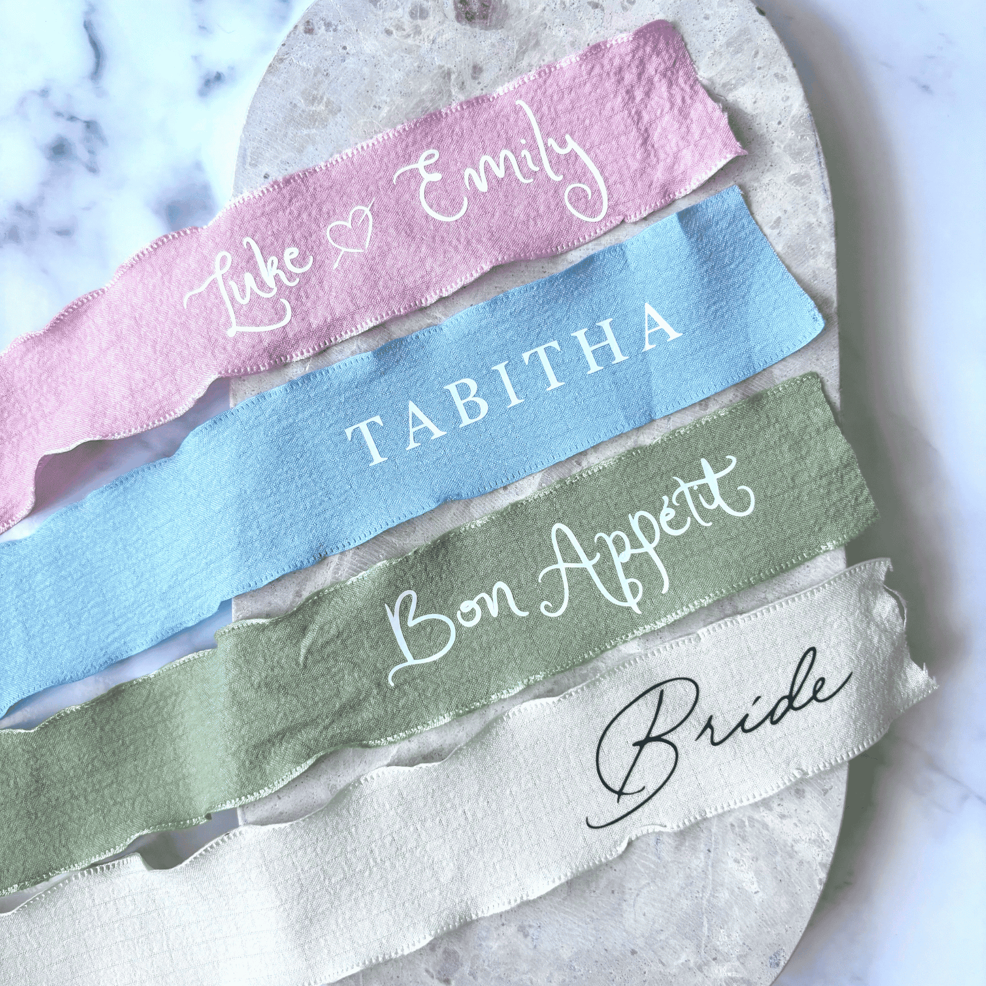 Personalised wedding ribbons in assorted colours, custom wedding stationery for menus or table décor