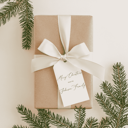 Handmade Christmas gift tag tied to wrapped present with ribbon, personalised stationery accessory for festive gifting