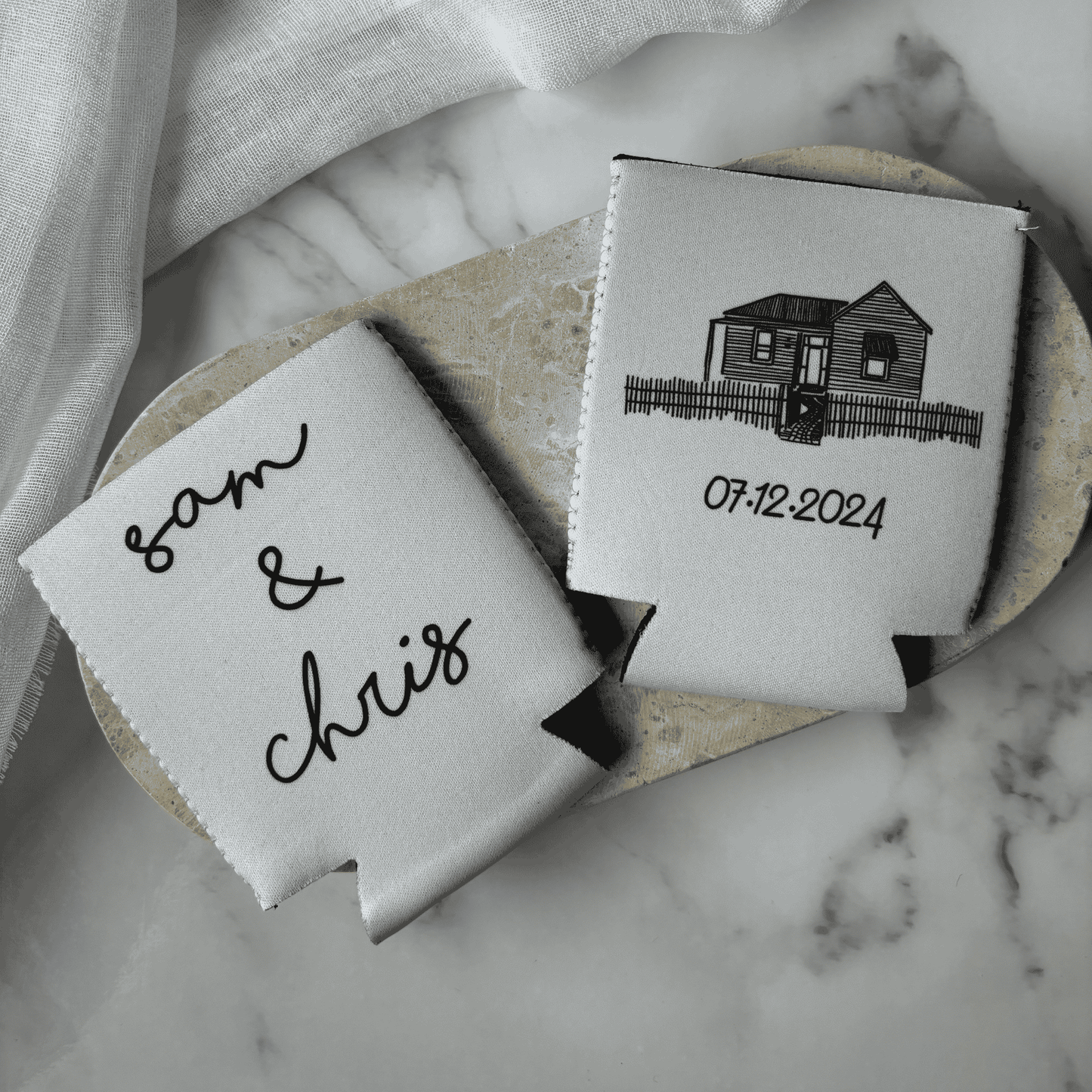 Custom wedding stubby holders featuring venue artwork and date, a practical wedding favour for bar signage and table styling