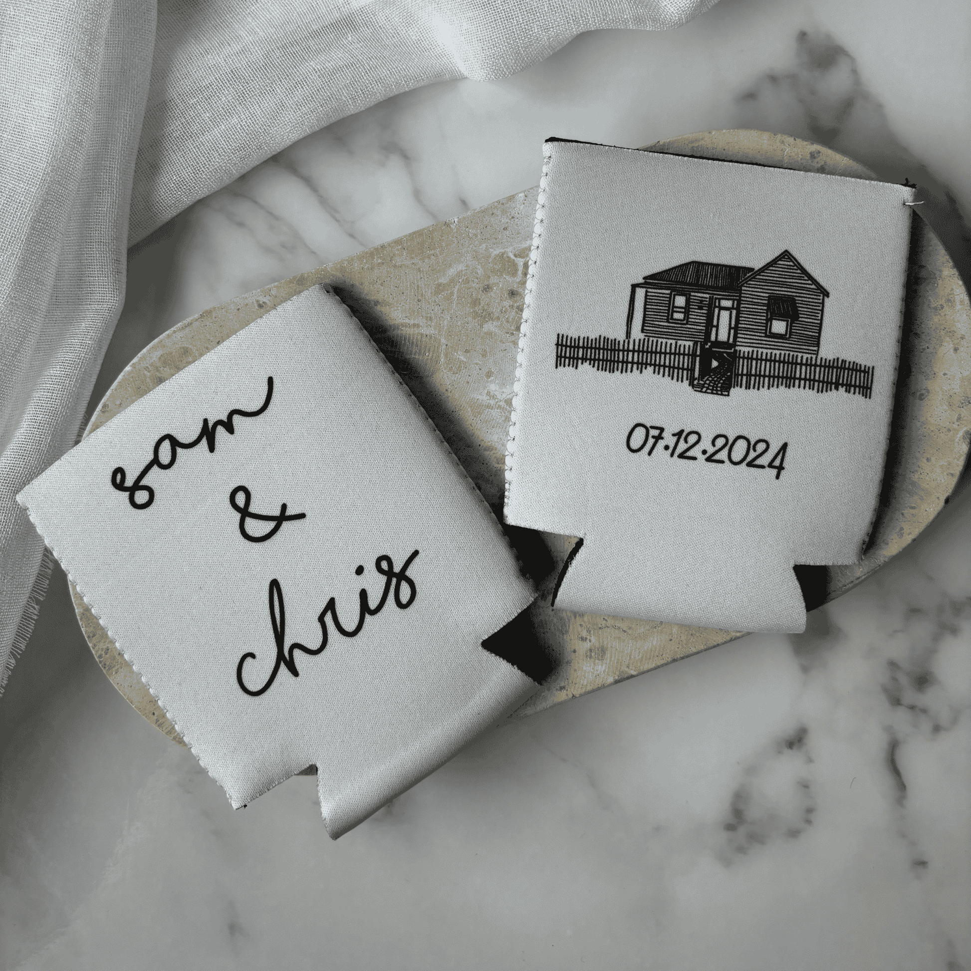 Custom wedding stubby holders featuring venue artwork and date, a practical wedding favour for bar signage and table styling