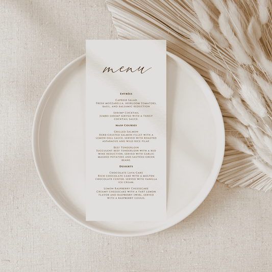 Wedding menu card styled on a plate with neutral linen and dried florals, part of a wedding invitation suite and coordinated wedding stationery